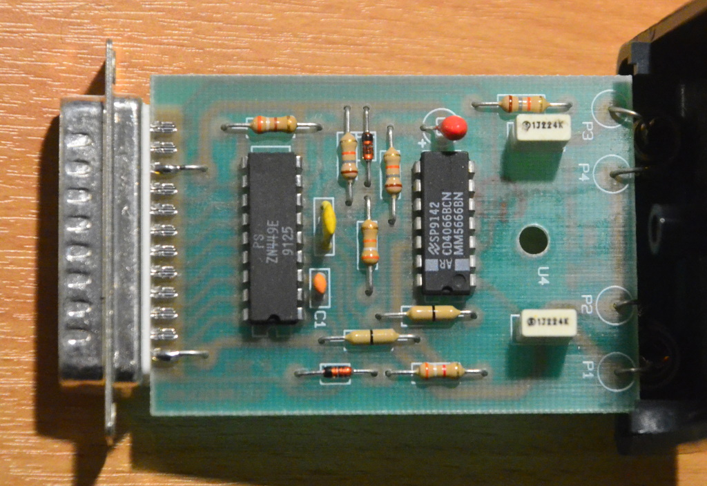 The circuit board has the 25 pin connector for the parallel port on the left and the two RCA audio connectors on the right