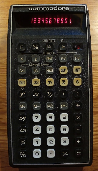 A black calculator with white, grey, black and beige keys. It has a display consisting of 11 red numbers.