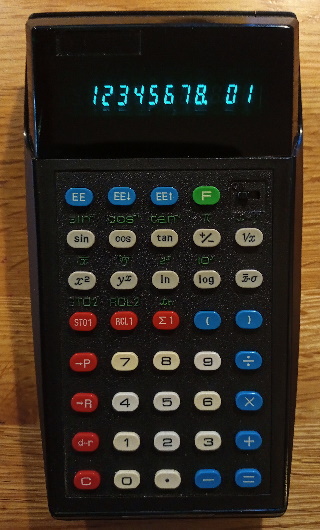 Black calculator with blue, red and white buttons and a green/blue fluorecent display.